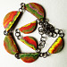 Necklace of orange, green, yellow and pink polymer beads with Asian theme reverse